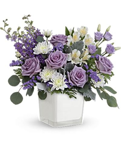 Loveliest lavender! Make any day feel extra special with the soft purple hues of this luxurious rose bouquet, presented in a soft white glass cube.

Lavender roses, white alstroemeria, lavender lisianthus, lavender larkspur, white cushion spray chrysanthemums and lavender sinuata statice are arranged with dusty miller, leatherleaf fern and silver dollar eucalyptus. Delivered in Teleflora's Color Splash cube.